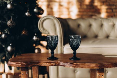 blue glasses against the background of a New Year's garland, selective focus, film and grain photo