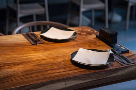 Close up of wooden table with two plates on it in cafe